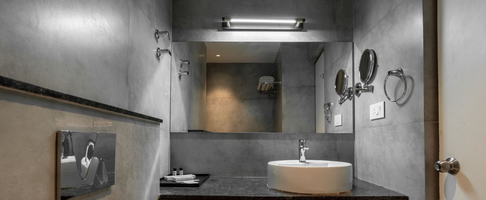 Bathroom with mirror, washbasin, and contemporary fittings at Hotel Royal Regency Chennai