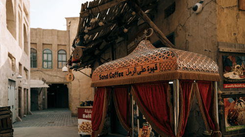 A colorful Bedouin-style tent shop in a souq selling traditional items.