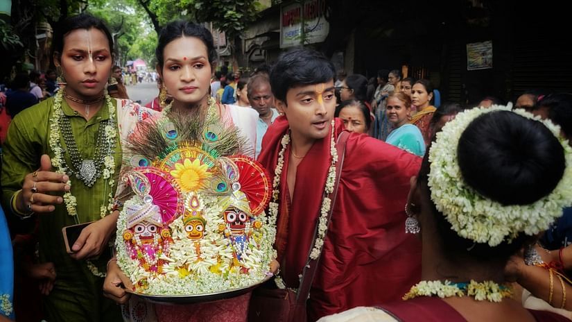 People holding idols of god showered by flowers