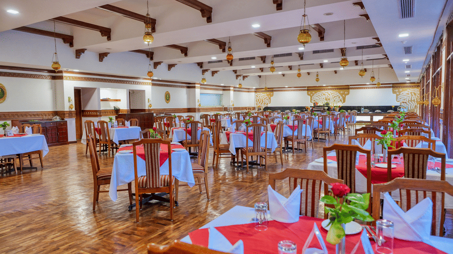 Darpan Restaurant at Clarks Khajuraho featuring several sets of tables and chairs.