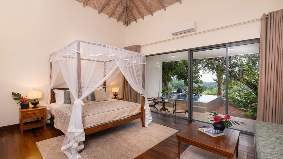  A beautifully designed bedroom featuring a canopy bed, modern furnishings, and direct access to a garden - Suite with Private Pool at Heavensa Villas and Suites by the Clarks, Galle
