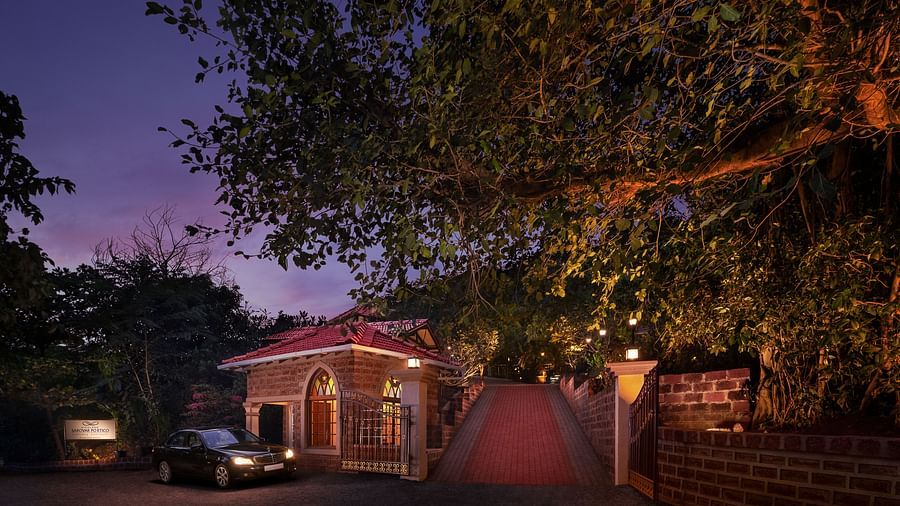 the entrance to our resort in Sindhudurg surrounded by towering trees - Highland Sarovar Portico, Sindhudurg