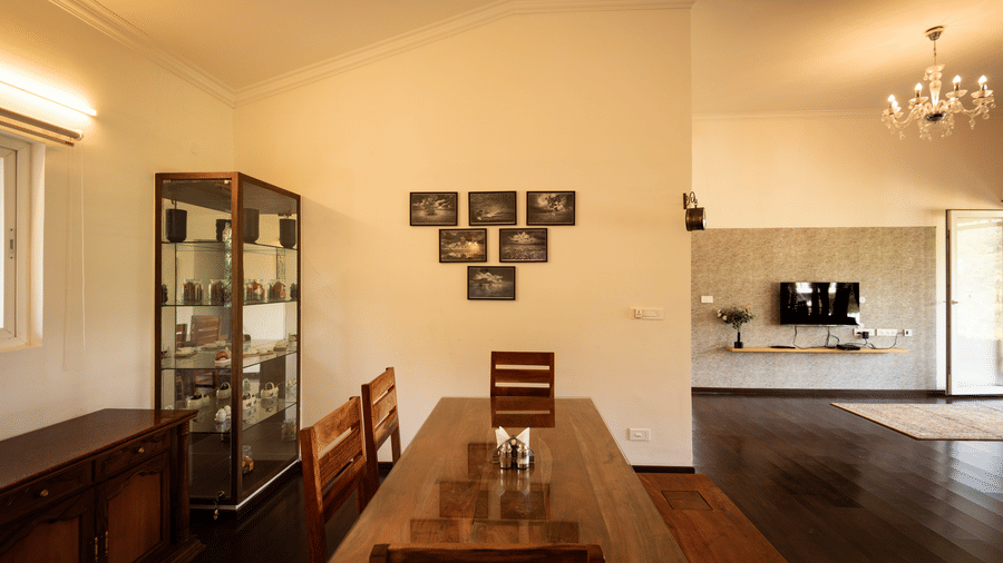 Spacious and elegantly designed dining area at Ibex Resort Kotagiri featuring warm lighting wooden flooring and contemporary furniture offering a serene atmosphere.