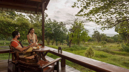 guests admiring the view from  Log Hut