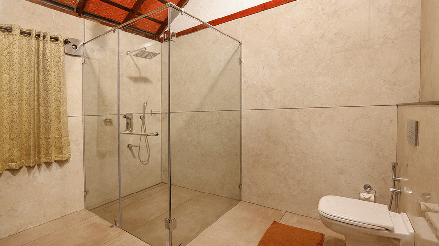 A glass cubicle and a wash basin in the bathroom | Vythiri Resort. Wayanad