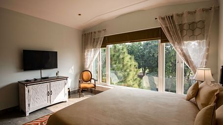  An image of a room with TV, big glass windows at BluSalzz Resort.