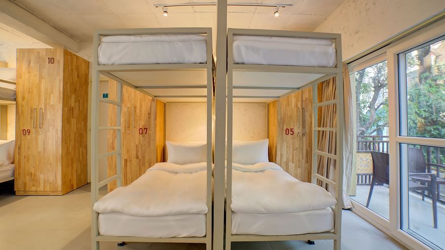 Four Bunk Beds side by side with a large window opening into a balcony on the right side - Bedzzz, Rishikesh