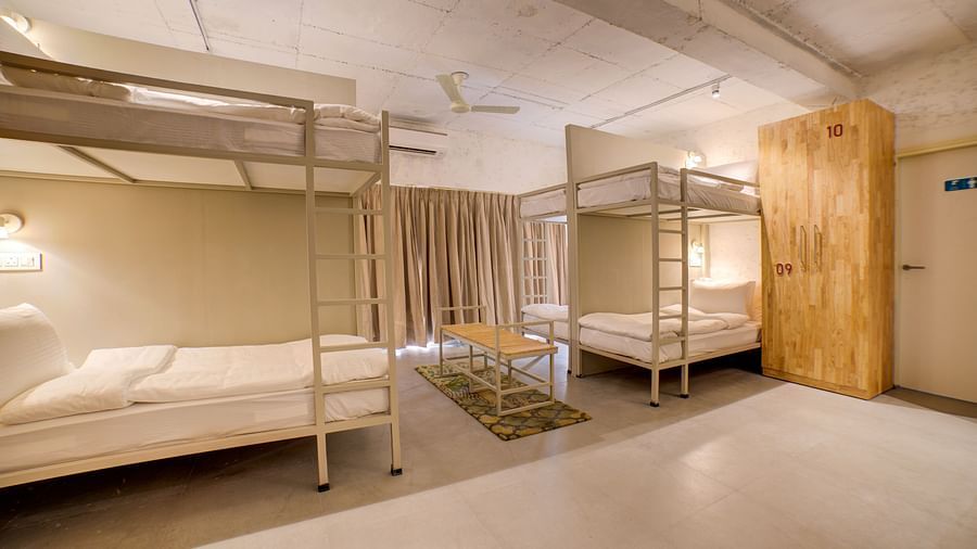 Two bunk beds across each other with a table in between - Bedzzz, Rishikesh