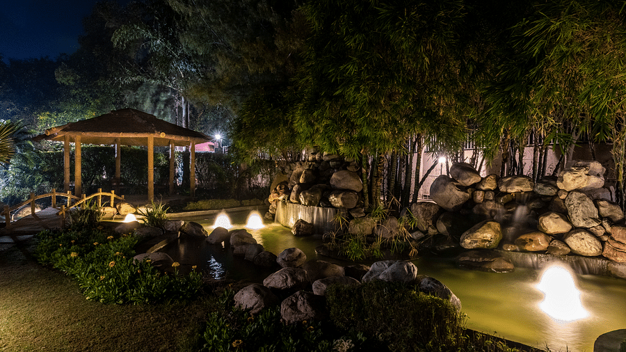 An image of a well-lit cosy garden at BluSalzz Resort during night time.