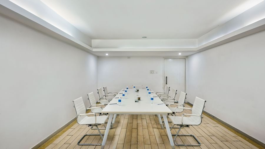Conference room with long white table and white chairs at Grande Bay Resort & Spa.