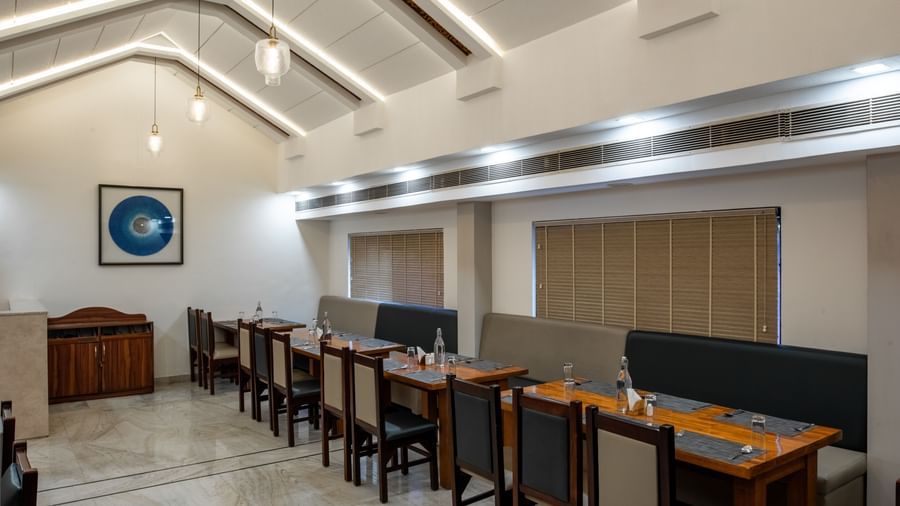 Restaurant dining area with neatly arranged tables and chairs at Hotel Royal Regency Chennai