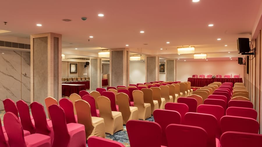 Banquet hall with theatre-style seating and stage setup at Hotel Royal Regency Chennai