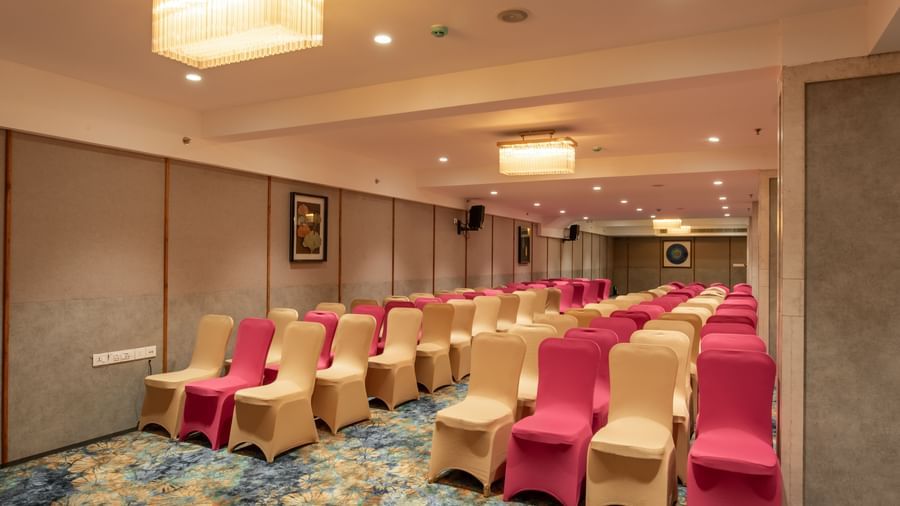 Event hall with mixed seating styles and carpet flooring at Hotel Royal Regency Chennai
