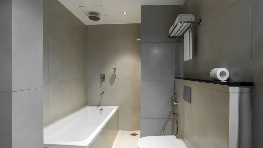 Bathroom with bathtub, shower, and modern fittings at Hotel Royal Regency Chennai