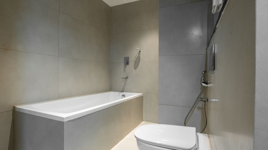 Modern bathroom with bathtub and shower facilities at Hotel Royal Regency Chennai