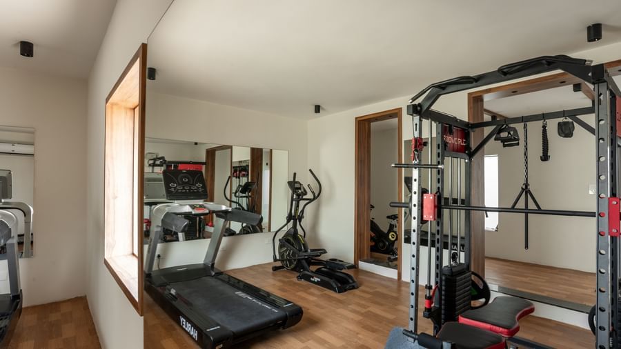 Fitness centre with treadmill and strength training equipment at Hotel Royal Regency