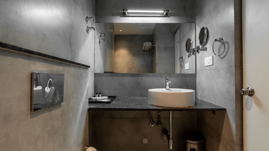Bathroom with mirror, washbasin, and contemporary fittings at Hotel Royal Regency Chennai