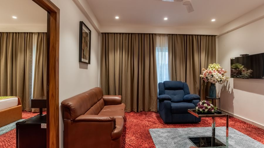 Suite-style room with separate seating and bedroom area at Hotel Royal Regency Chennai