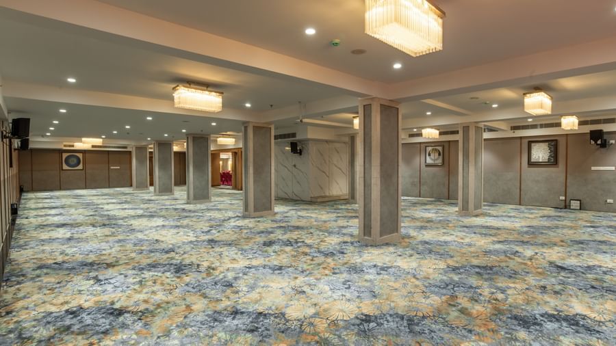 Large event hall with elegant ceiling lights at Hotel Royal Regency Chennai