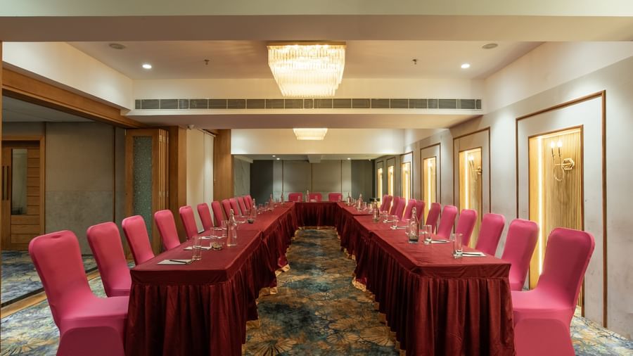 Event space with U-shaped seating arrangement in red chairs at Hotel Royal Regency Chennai