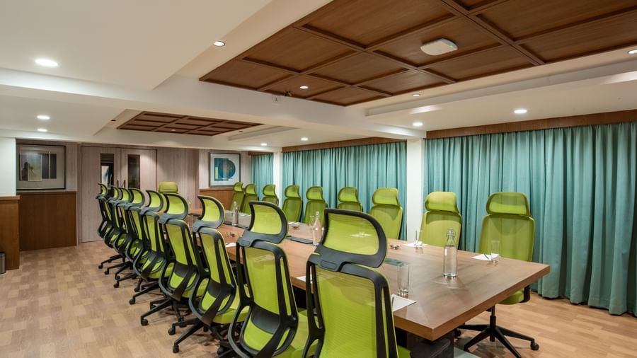 Conference hall with seating arranged around a meeting table at Hotel Royal Regency Chennai