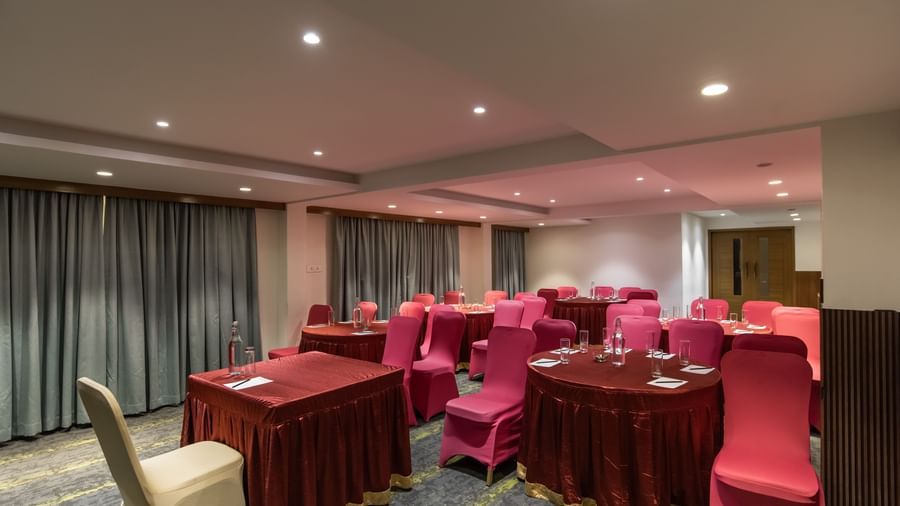 Event space with rectangular tables and cushioned seating at Hotel Royal Regency Chennai