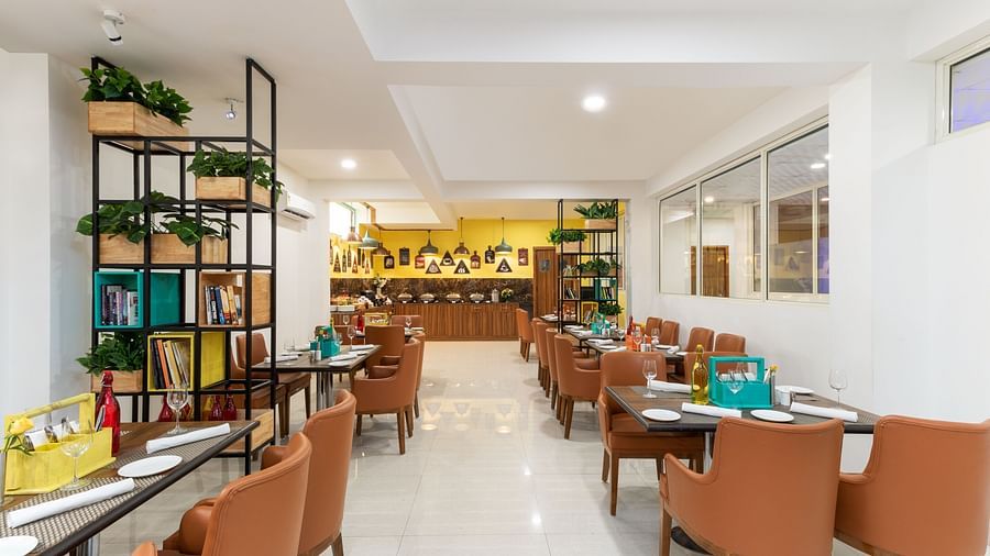 Cafe Inde seating area with chic ambience and brown chairs | Inde Hotel Cyber City