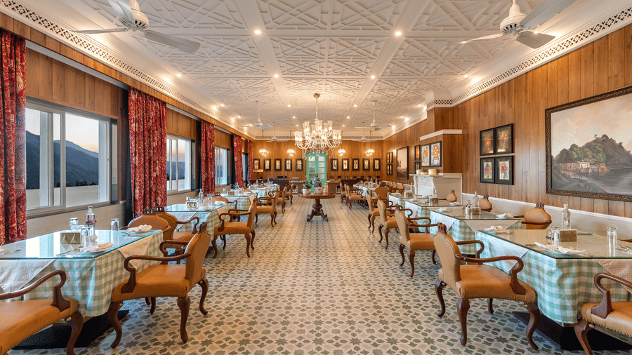 Spacious dining hall with large windows and mountain views at Mayfair Manor, Jungpana.
