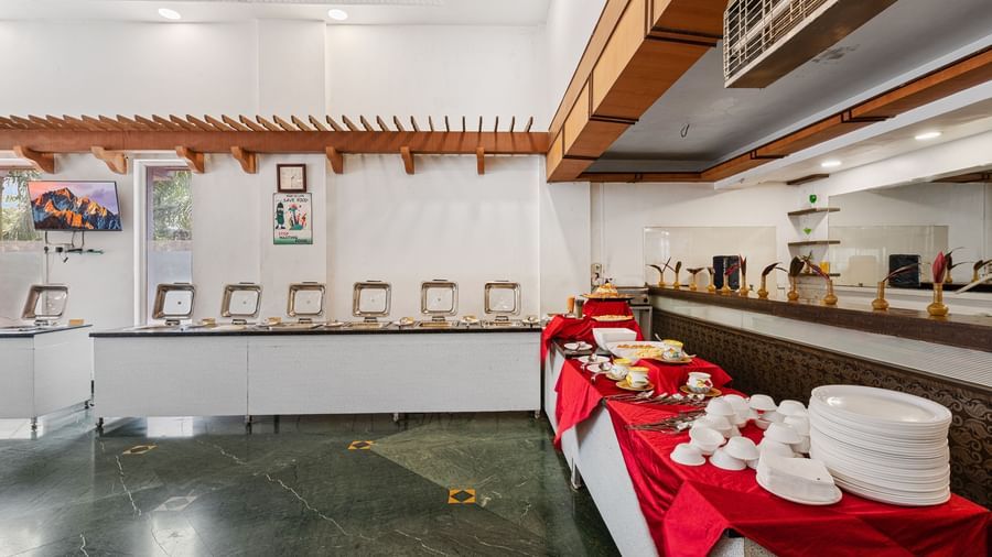 Buffet section at The Darbar Restaurant featuring a simple and elegant interior at Mayur Retreat.