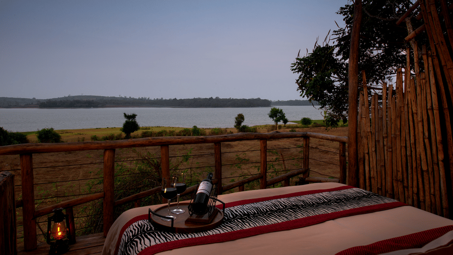 Resort deck overlooking the Kabini river at dusk at Evolve Back Kabini
