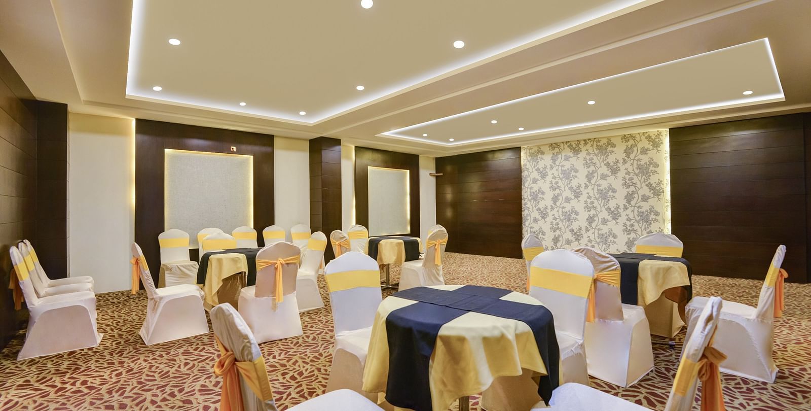 A shot of white table and chairs arranged for an event t the banquet hall.