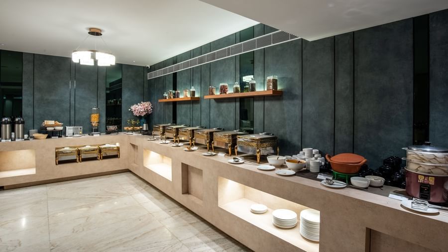Buffet counter with a wide variety of dishes at Hotel Royal Regency Chennai