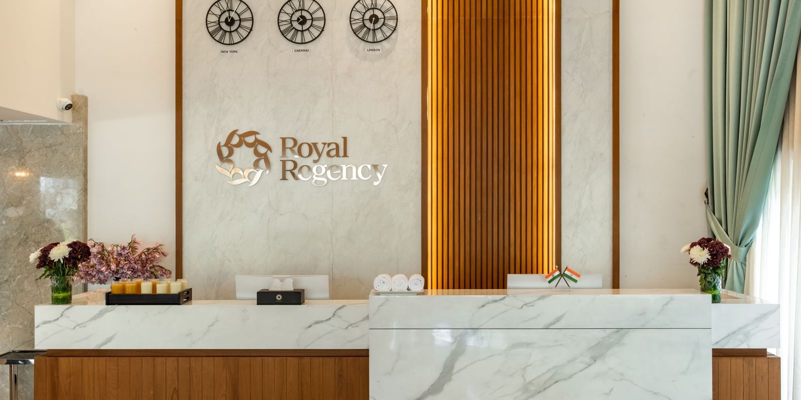 Reception desk with Royal Regency branding and decor at Hotel Royal Regency Chennai
