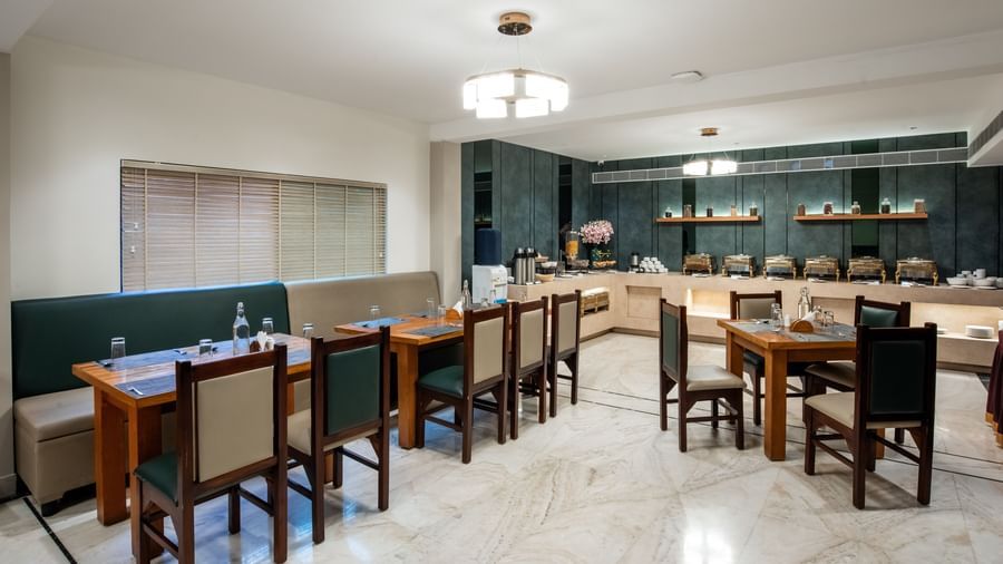 Casual dining area with modern decor and seating at Hotel Royal Regency Chennai
