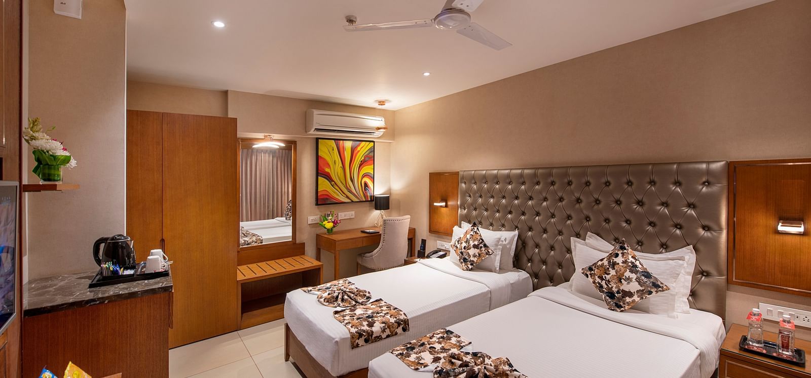 Twin bed room with bed post, dressing table with mirror, side table and AC