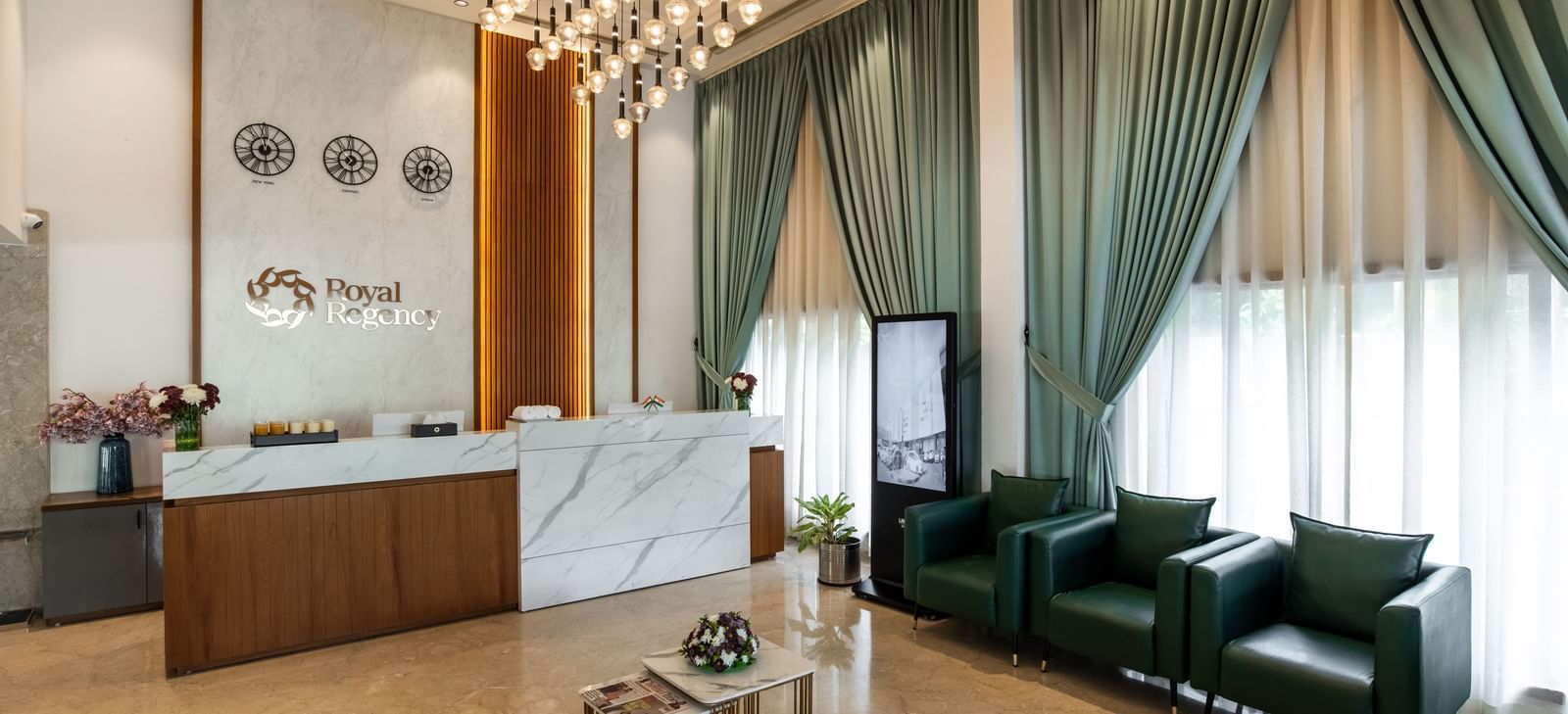 Lobby with modern seating arrangement and elegant curtains at Hotel Royal Regency Chennai