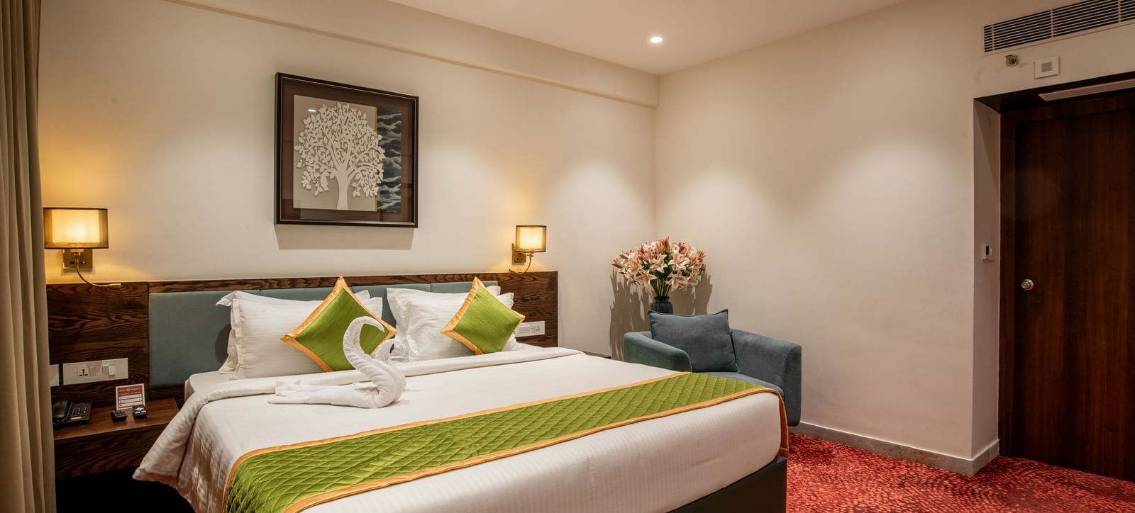 Bedroom featuring king size bed, bedside lamps, and warm lighting at Hotel Royal Regency Chennai