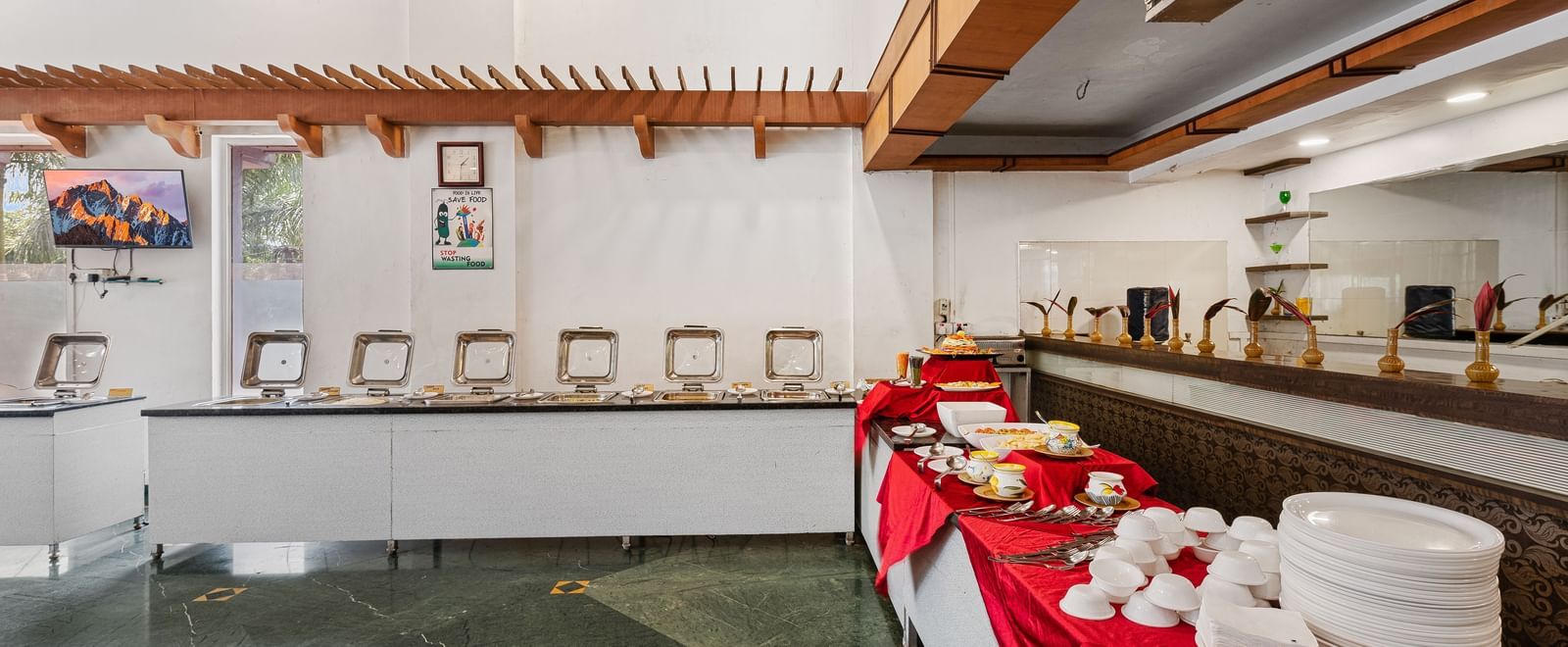 Buffet section at The Darbar Restaurant featuring a simple and elegant interior at Mayur Retreat.
