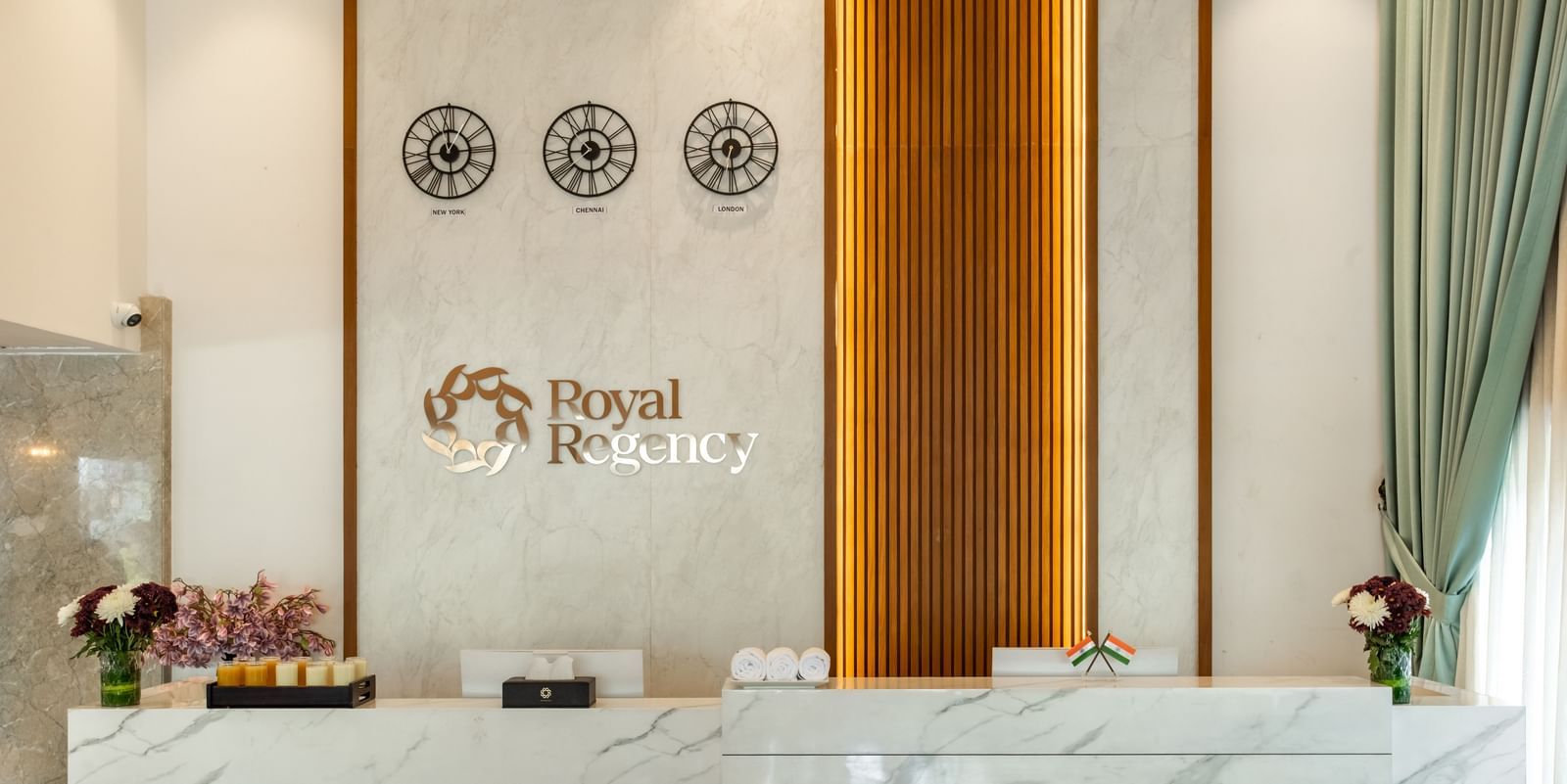 Reception desk with Royal Regency branding and decor at Hotel Royal Regency Chennai