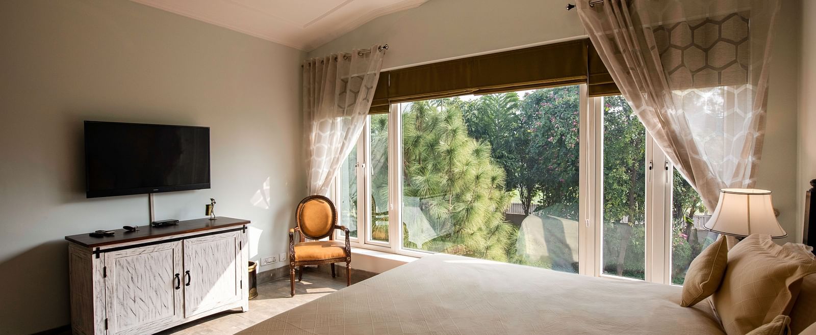  An image of a room with TV, big glass windows at BluSalzz Resort.