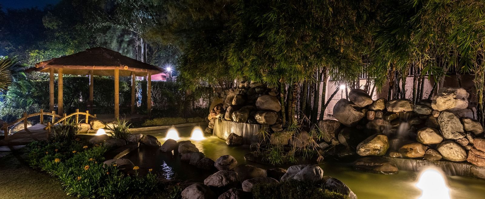 An image of a well-lit cosy garden at BluSalzz Resort during night time.