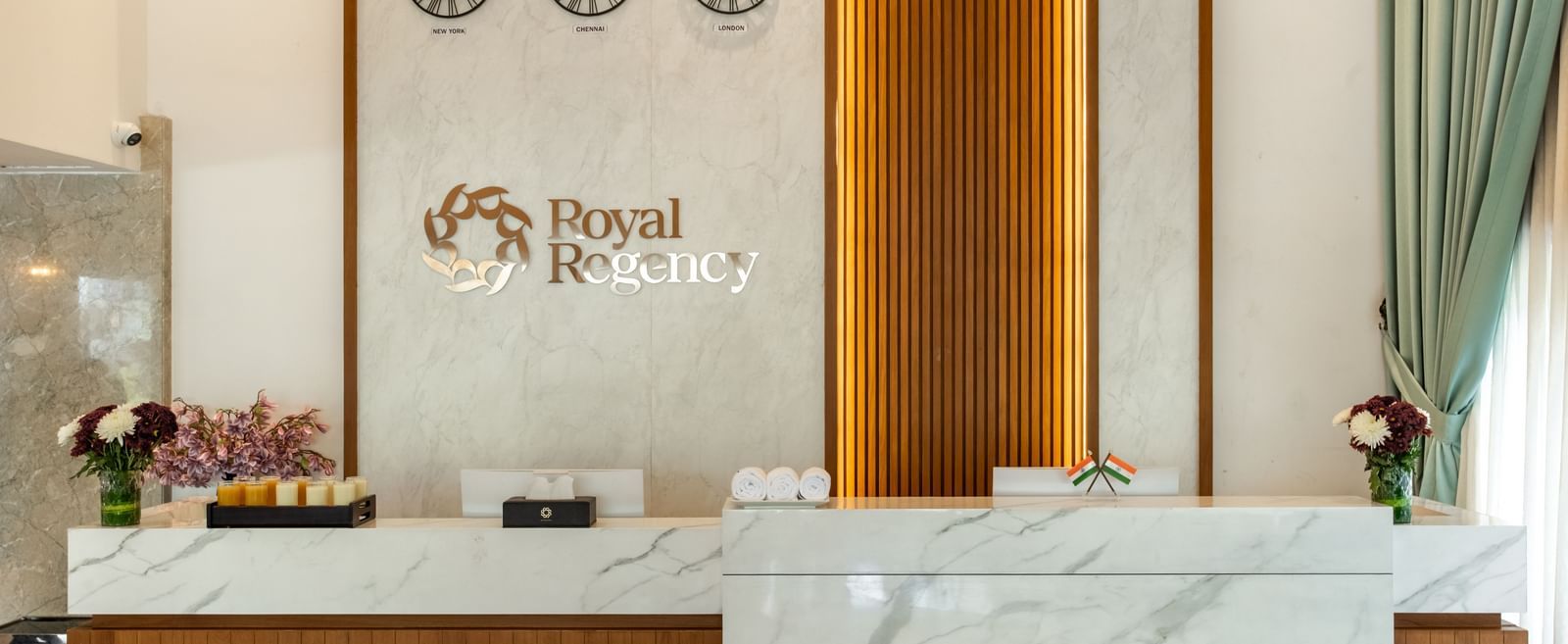 Reception desk with Royal Regency branding and decor at Hotel Royal Regency Chennai