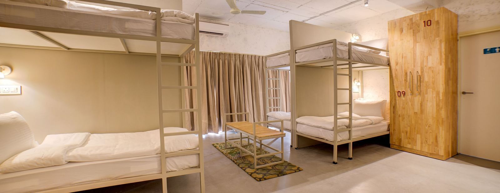 Two bunk beds across each other with a table in between - Bedzzz, Rishikesh