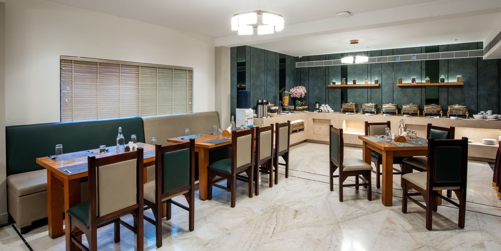 Casual dining area with modern decor and seating at Hotel Royal Regency Chennai