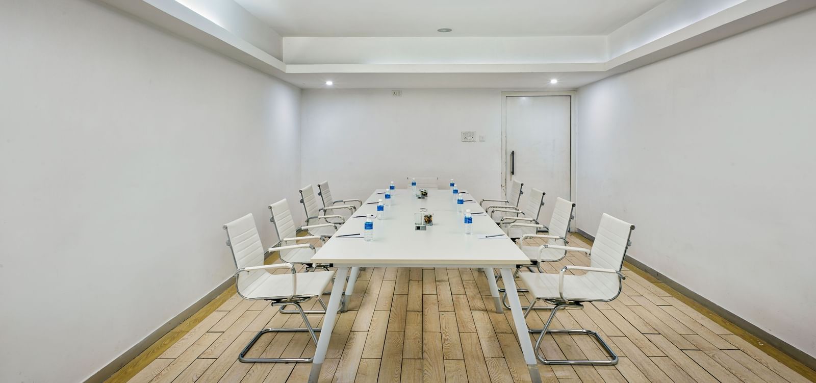 Conference room with long white table and white chairs at Grande Bay Resort & Spa.