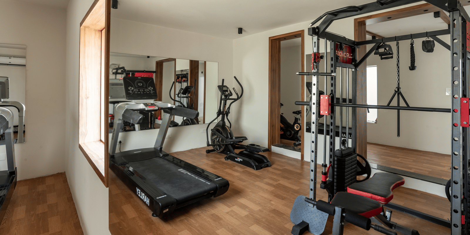 Fitness centre with treadmill and strength training equipment at Hotel Royal Regency