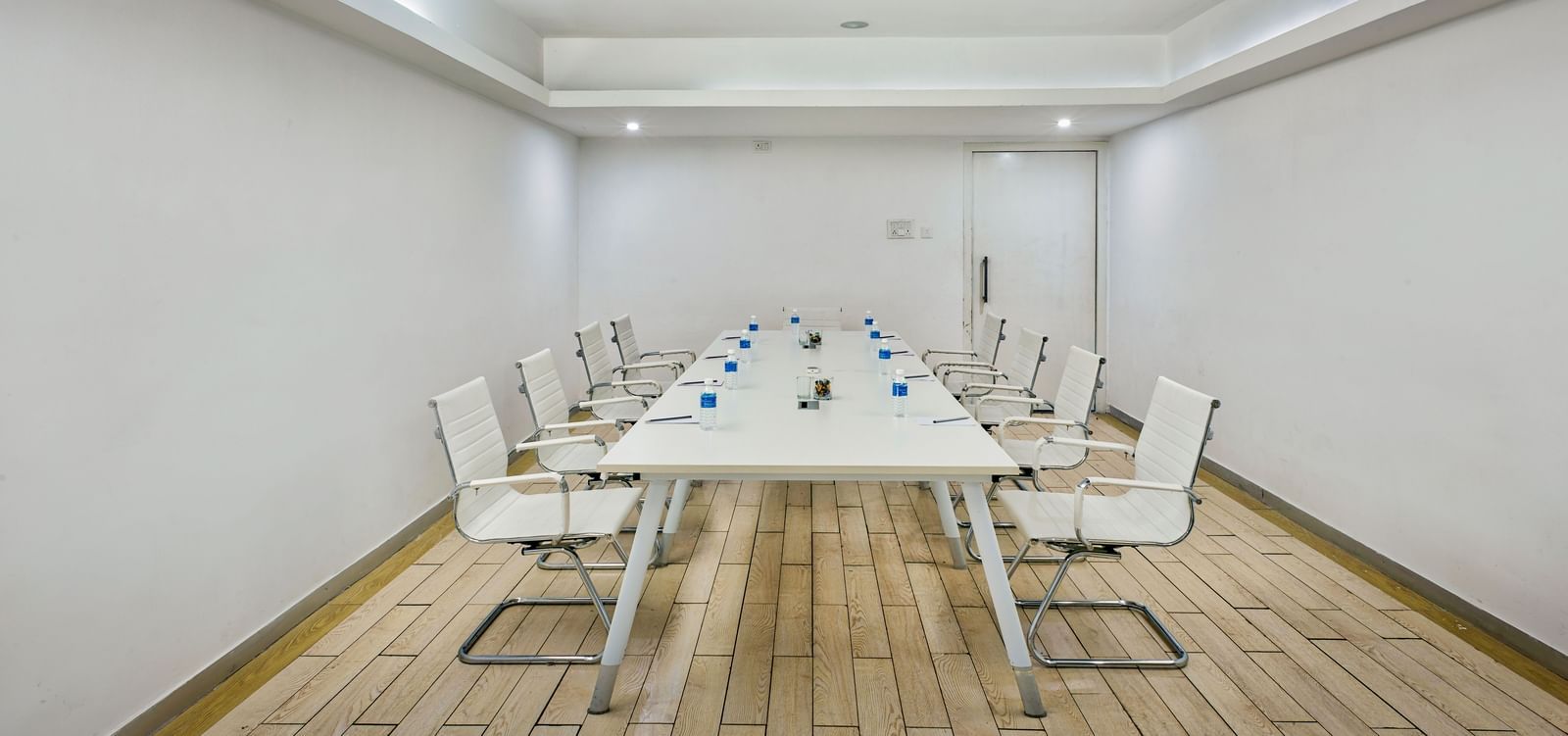 Conference room with long white table and white chairs at Grande Bay Resort & Spa.