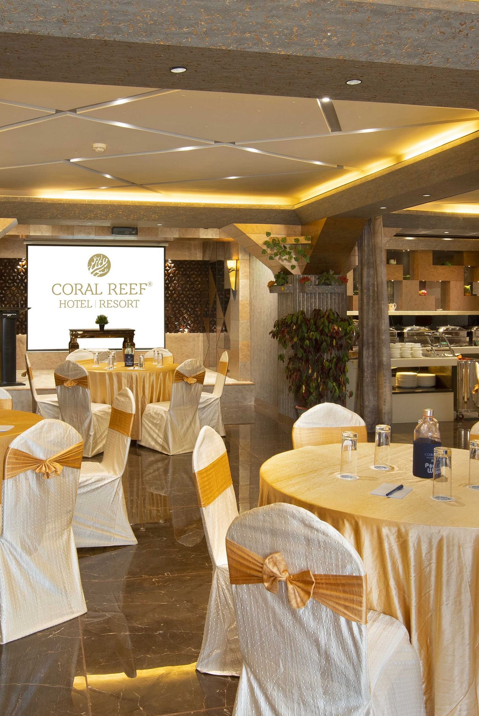 A banquet hall with multiple sets of chairs and tables in a round table fashion.