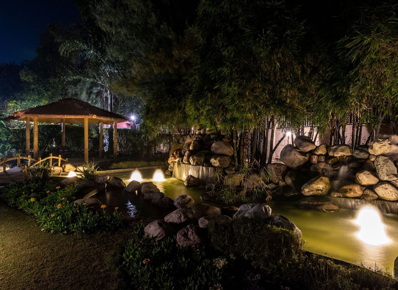 An image of a well-lit cosy garden at BluSalzz Resort during night time.