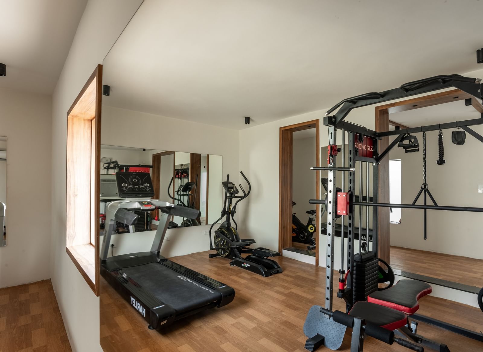 Fitness centre with treadmill and strength training equipment at Hotel Royal Regency